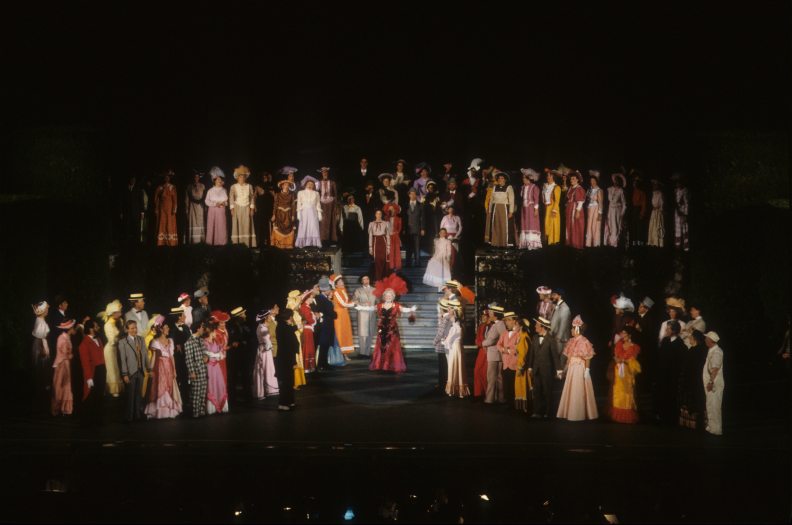 A theater company performs a scene from Hello Dolly! on stage