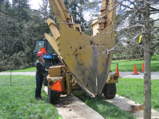 a person in a red hard hat operating a large piece of construction equipment