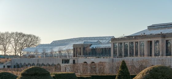 View of the exteriors of the East and West Conservatories as seen through the top of the topiary garden. 