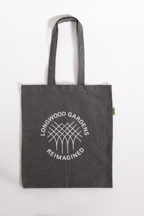 A dark gray tote bag against a white backdrop featuring the words Longwood Gardens Reimagined.