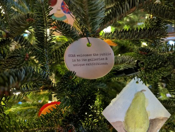 Handmade ornaments hanging on a Christmas tree.